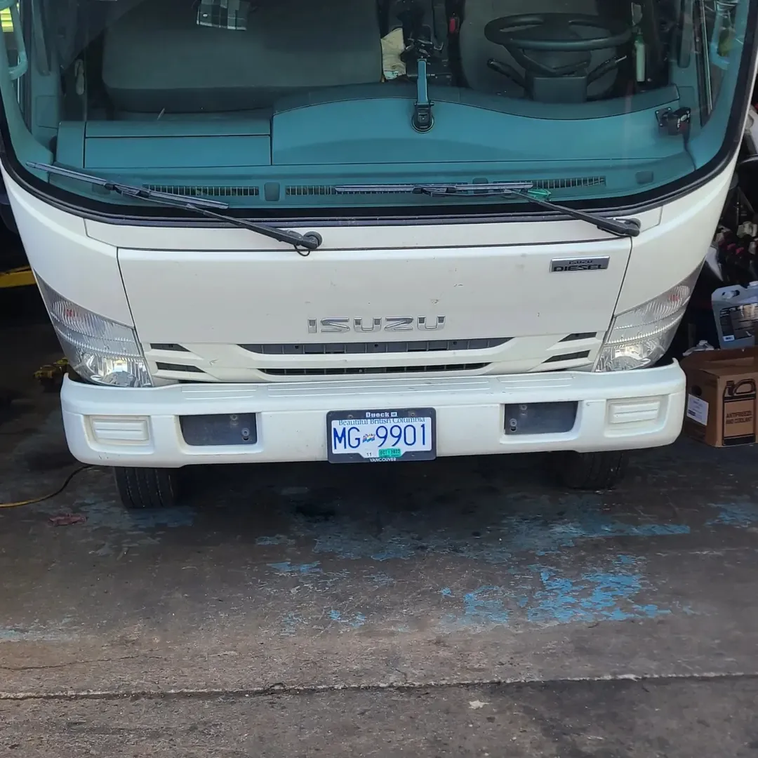 White Isuzu NRR commercial truck inside the Gill Motors workshop